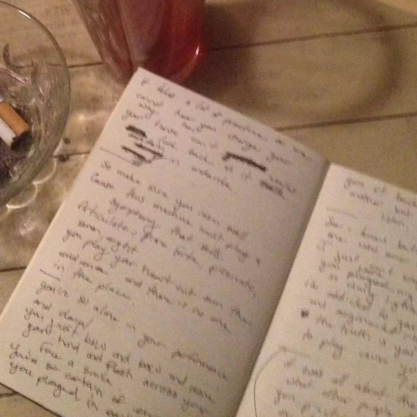 The Perfect Journal sits on the floor beside a full ashtray and an empty pint of beer. 